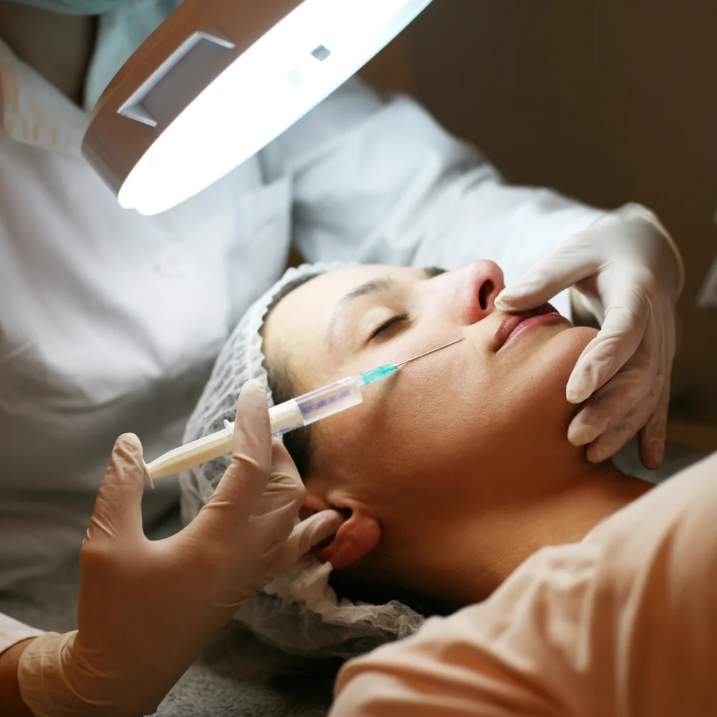 Facial injection performed under a clinical examination lamp