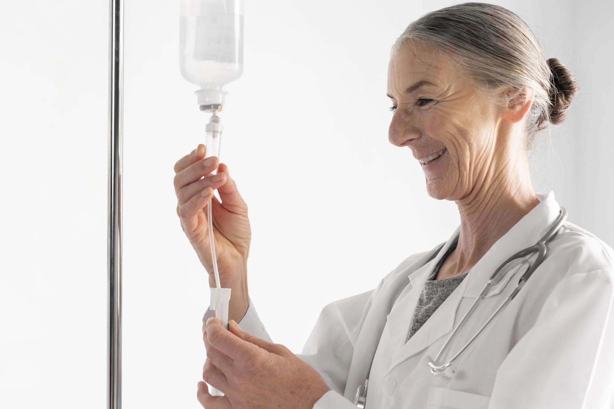 A doctor checking an intravenous infusion line during a session