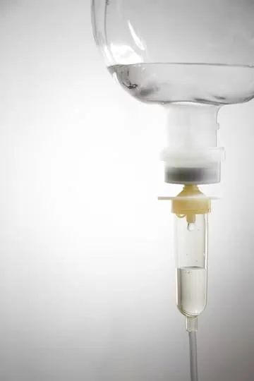 A saline solution bag hanging on a drip stand
