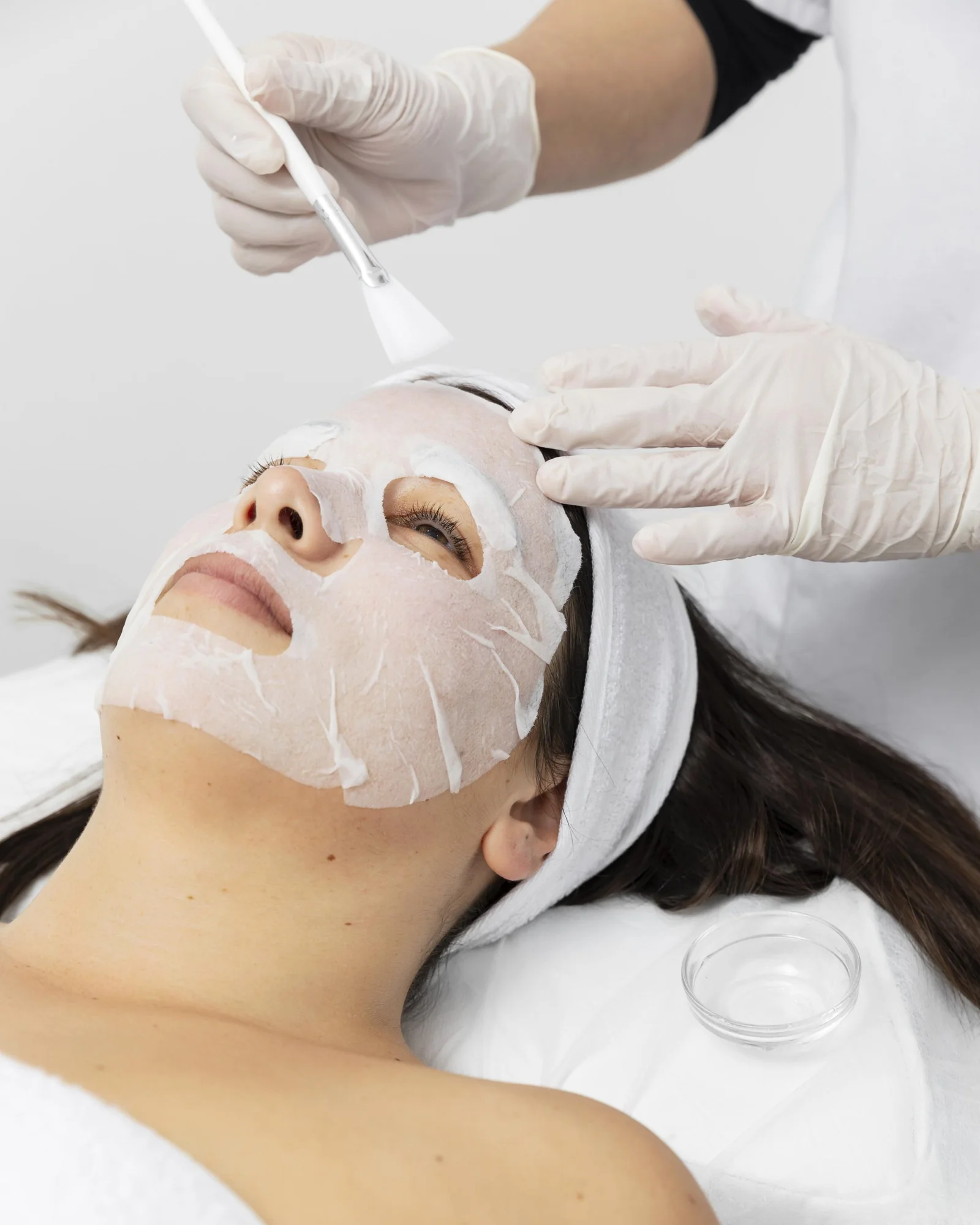 A woman resting during a facial skincare treatment